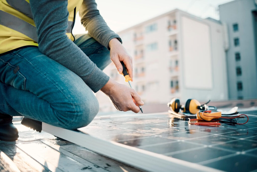 Photovoltaik Installateur montiert Solarmodule auf einem Dach